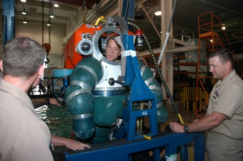 US Navy 090802-N-1580K-028 Chief of Navy Reserve Vice Adm. Dirk Debbink asks Cmdr. Brian Granger nd Chief Navy Diver Eric Taylor about the capabilities of the atmospheric diving system