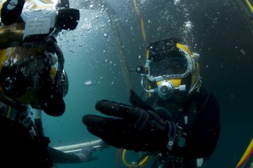 US Navy 100722-N-1134I-063 Navy Diver 2nd Class Troy Crowder uses hand signals to communicate with a Mexican navy diver during a salvage recovery exercise