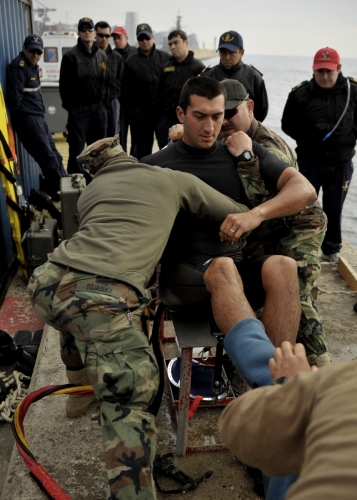 US Navy 110629-N-KB666-125 Divers prepare Navy Diver 3rd Class Bryan Myers for an emergency surface decompression during a demonstration for the Ar